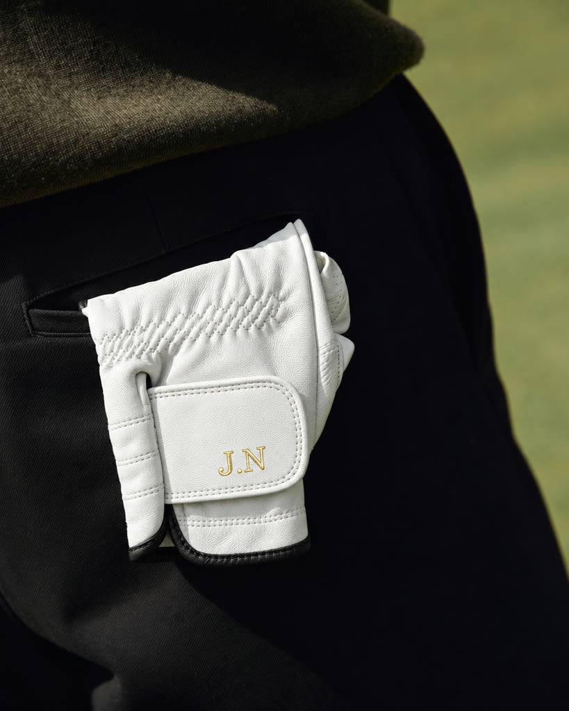 The Monogram Glove tucked in a back trouser pocket, initials J.N showing.